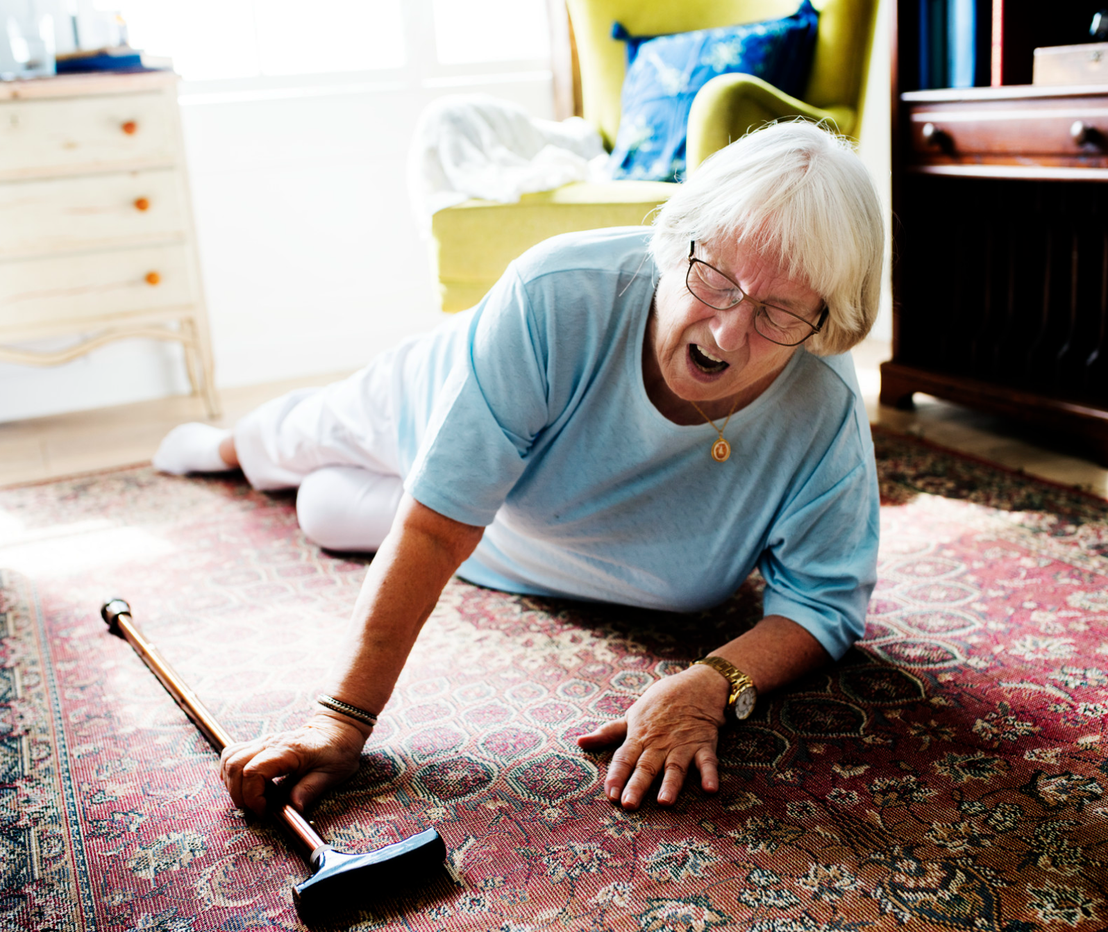 A senior who has fallen at home, reaching for help